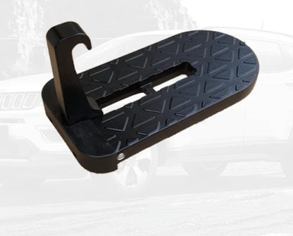 Black door step with a textured surface on a white background