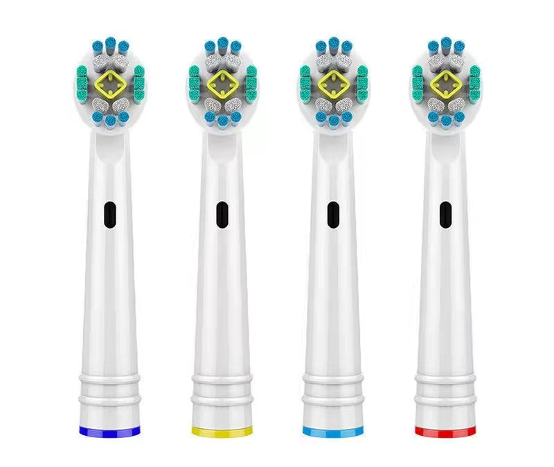 Four toothbrush heads with colored bristle patterns on a white background
