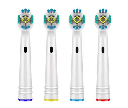 Four toothbrush heads with colored bristle patterns on a white background