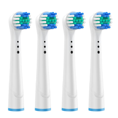 Four white electric toothbrush heads with blue and green bristle patterns on a white background