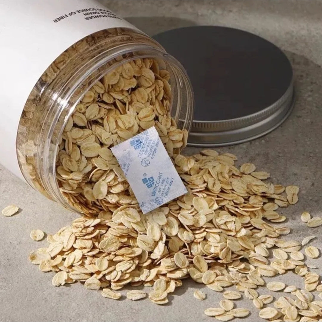 Jar of oats with a silica gel packet on a gray surface