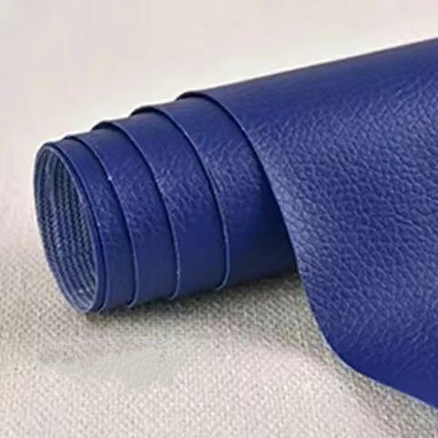 Roll of blue leatherette on a textured gray surface