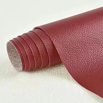 Roll of red leather-like material on a white background