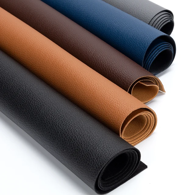 Rolls of leather in black, brown, and blue on a white background