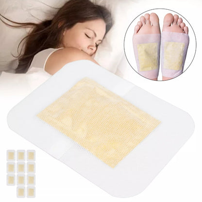 Woman lying down with detox foot patches on her feet and a tray of patches.
