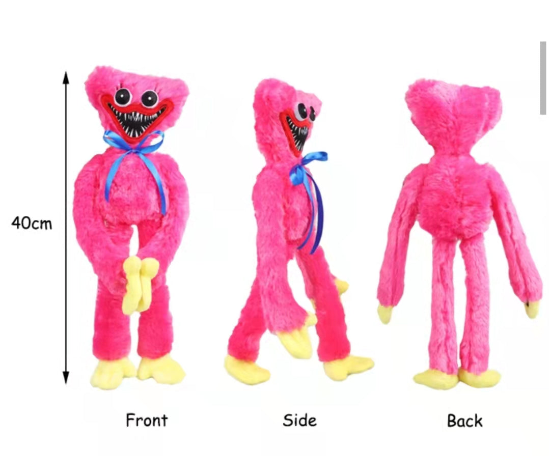 huggie wuggie Pink plush toy with blue ribbon and yellow paws, shown from front, side, and back on a white background.