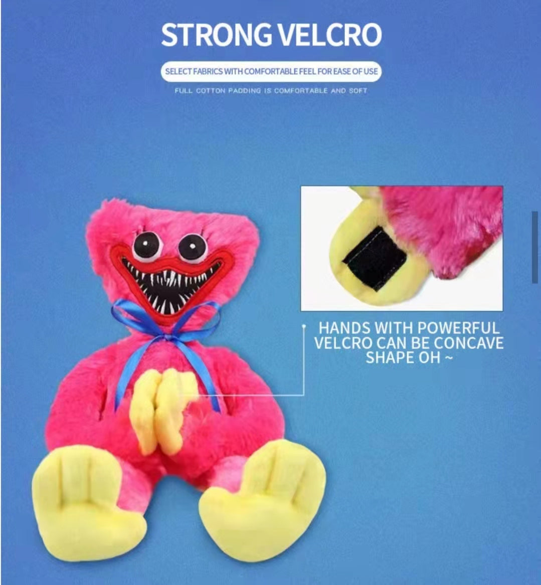 huggie wuggie Pink plush toy with yellow feet on a blue background, featuring text about strong velcro.