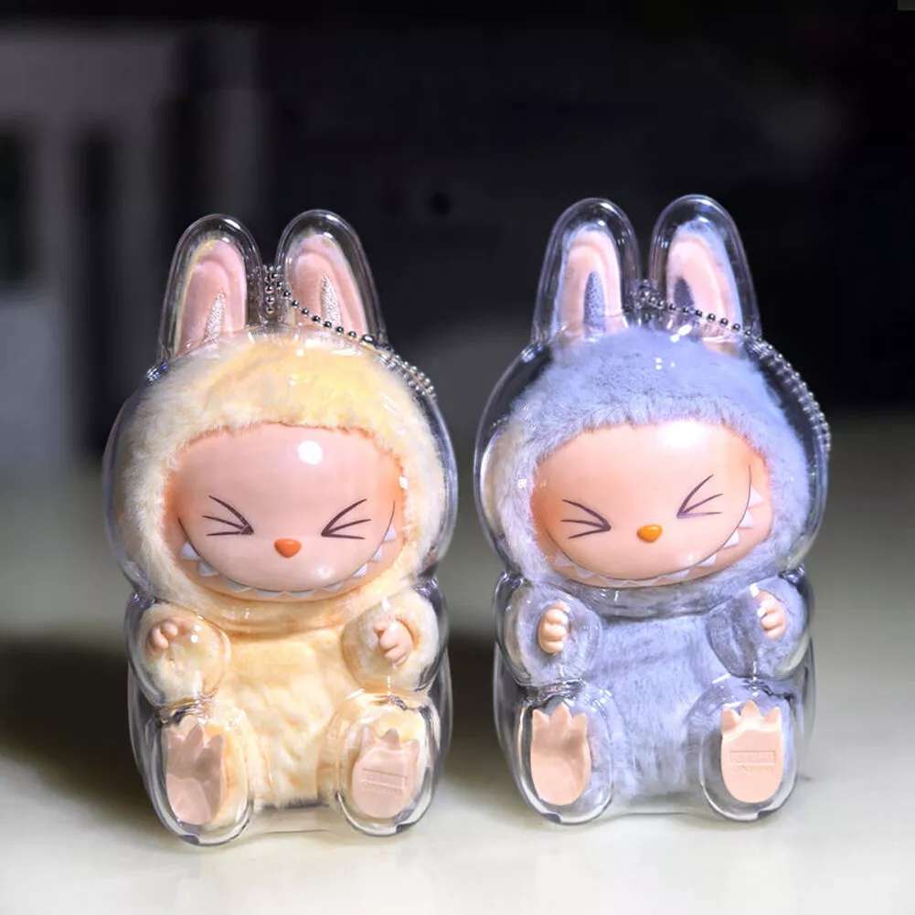 labubu Two cartoon rabbit figurines in clear plastic cases on a light background