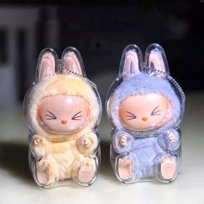labubu Two cartoon rabbit figurines in clear plastic cases on a light background